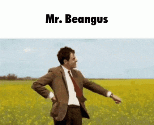 A Man In A Suit And Tie Is Standing In A Field With The Words Mr. Beangus Above Him GIF