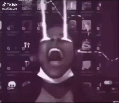 A Man In A Suit And Tie Is Standing In A Foggy Room With A Lightning Bolt Behind Him . GIF