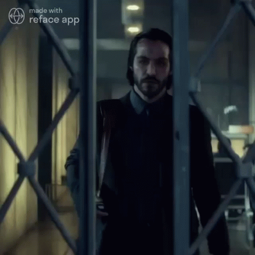 a man in a suit and tie is standing in a hallway behind a fence made with reface app
