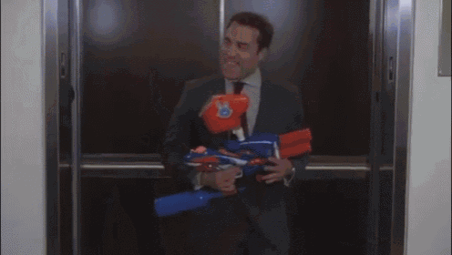 A Man In A Suit And Tie Is Standing In A Hallway Holding A Folder GIF