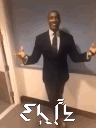 A Man In A Suit And Tie Is Standing In A Hallway With His Arms Outstretched And The Word Exit Written In White Letters GIF