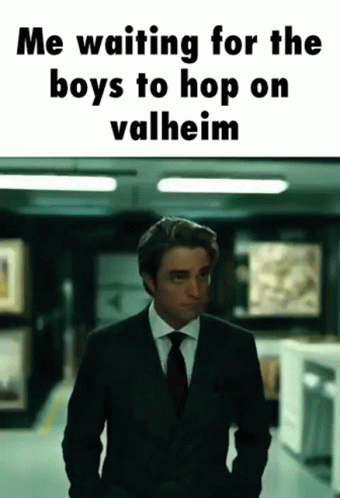 A Man In A Suit And Tie Is Standing In A Hallway With The Caption " Me Waiting For The Boys To Hop On Valheim " GIF