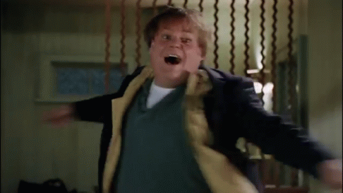 A Man In A Suit And Tie Is Standing In A Room With A Fence In The Background . GIF