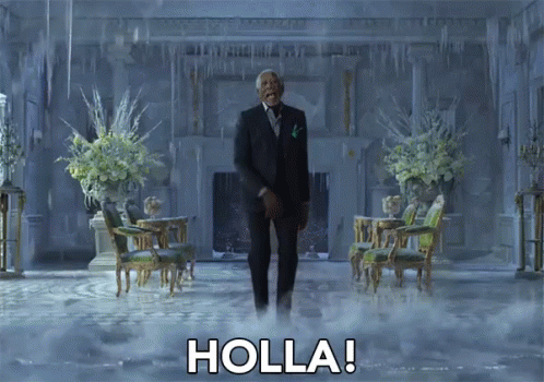 A Man In A Suit And Tie Is Standing In A Room With Holla Written On The Floor GIF