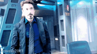 A Man In A Suit And Tie Is Standing In A Room With The Name Gravello2023 In The Corner GIF