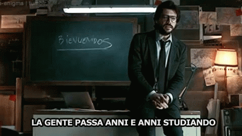 A Man In A Suit And Tie Is Standing In Front Of A Blackboard That Says Bienvenidos GIF