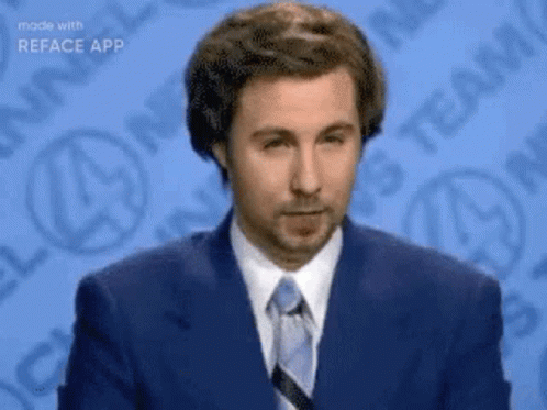 A Man In A Suit And Tie Is Standing In Front Of A Blue Background With Logos . GIF