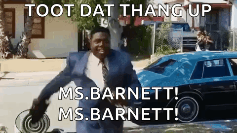 A Man In A Suit And Tie Is Standing In Front Of A Blue Car With The Words Toot Dat Thang Up Ms Barnett GIF