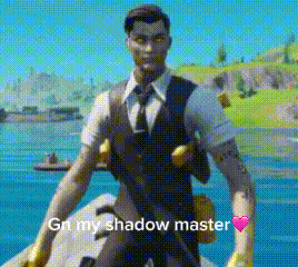 A Man In A Suit And Tie Is Standing In Front Of A Body Of Water Holding A Gun . GIF