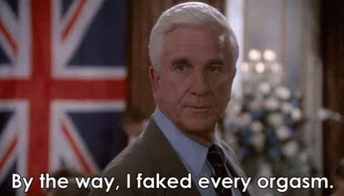 A Man In A Suit And Tie Is Standing In Front Of A British Flag And Says By The Way I Faked Every Orgasm . GIF