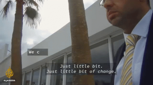 A Man In A Suit And Tie Is Standing In Front Of A Building With The Words We C Just Little Bit Just Little Bit Of Change GIF