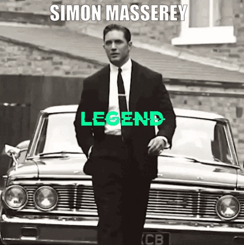 A Man In A Suit And Tie Is Standing In Front Of A Car With The Word Legend Written On It GIF