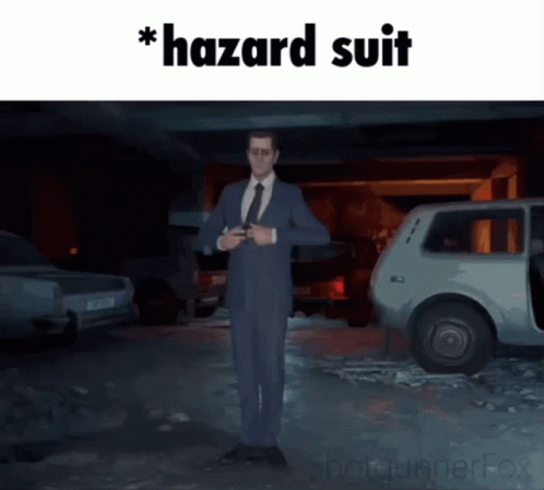 A Man In A Suit And Tie Is Standing In Front Of A Car With The Words Hazard Suit Written On The Bottom GIF