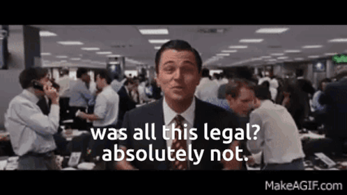 A Man In A Suit And Tie Is Standing In Front Of A Crowd Of People . GIF