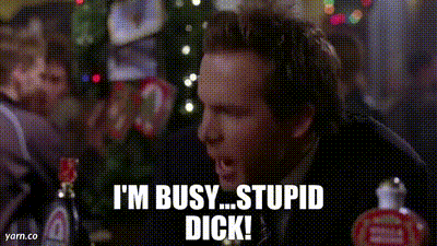 A Man In A Suit And Tie Is Standing In Front Of A Crowd Of People . GIF