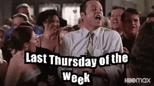 A Man In A Suit And Tie Is Standing In Front Of A Crowd Of People And Screaming . GIF