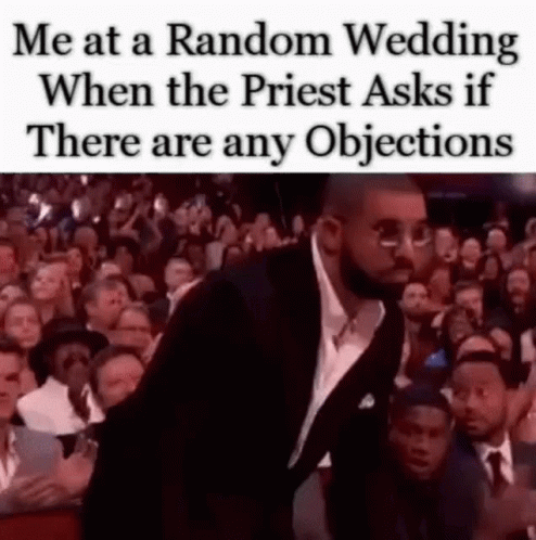 A Man In A Suit And Tie Is Standing In Front Of A Crowd Of People At A Wedding . GIF
