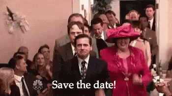 A Man In A Suit And Tie Is Standing In Front Of A Crowd Of People With The Words `` Save The Date '' . GIF