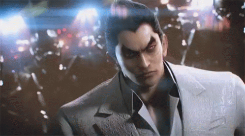 A Man In A Suit And Tie Is Standing In Front Of A Crowd . GIF