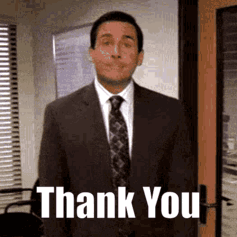 A Man In A Suit And Tie Is Standing In Front Of A Door And Says Thank You . GIF