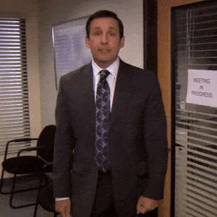 A Man In A Suit And Tie Is Standing In Front Of A Door That Says Meeting In Progress GIF