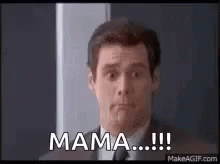 A Man In A Suit And Tie Is Standing In Front Of A Door . GIF