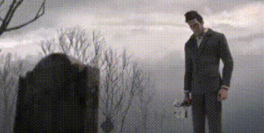 A Man In A Suit And Tie Is Standing In Front Of A Grave In A Cemetery . GIF