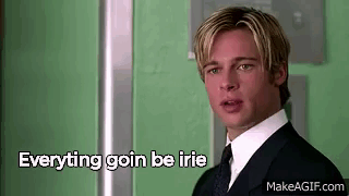 A Man In A Suit And Tie Is Standing In Front Of A Green Wall With The Words `` Everything Goin Be Irie '' . GIF