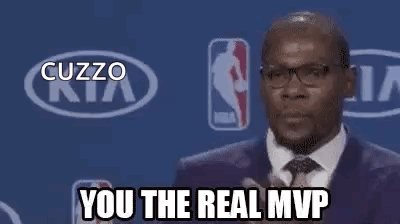 A Man In A Suit And Tie Is Standing In Front Of A Kia Logo And A Basketball Player . GIF