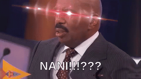 A Man In A Suit And Tie Is Standing In Front Of A Microphone With Red Lights Coming Out Of His Eyes And Says Nan ! GIF
