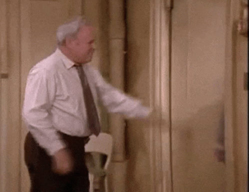 Man In Suit And Tie Standing In Front Of Mirror GIF