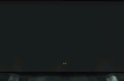 A Man In A Suit And Tie Is Standing In Front Of A Screen With The Letter D On It GIF