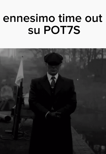 A Man In A Suit And Tie Is Standing In Front Of A Sign That Says " Ennesimo Time Out Su Pot7s " GIF