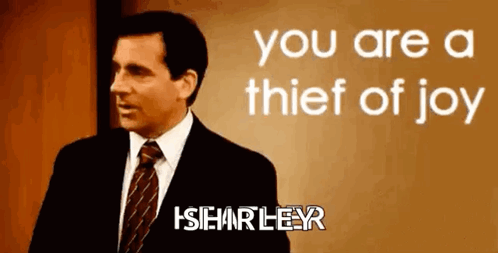 A Man In A Suit And Tie Is Standing In Front Of A Sign That Says " You Are A Thief Of Joy " GIF