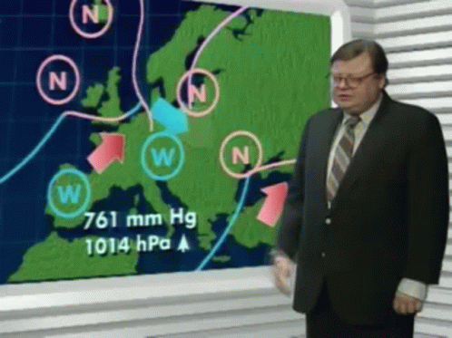 A Man In A Suit And Tie Is Standing In Front Of A Weather Map GIF