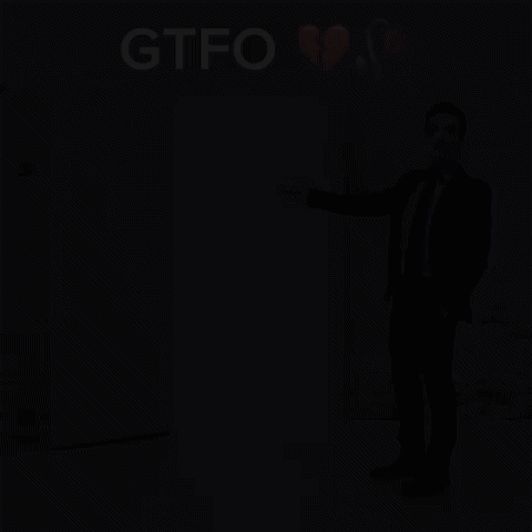A Man In A Suit And Tie Is Standing In Front Of A White Door With The Word Gtfo Above It GIF