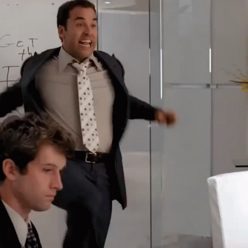 A Man In A Suit And Tie Is Standing In Front Of A Whiteboard That Says Got 7Th GIF