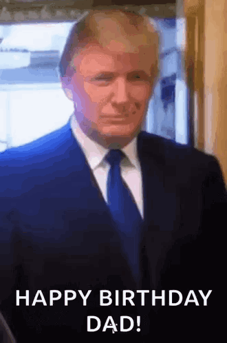 A Man In A Suit And Tie Is Standing In Front Of A Window And Says `` Happy Birthday Dad '' . GIF