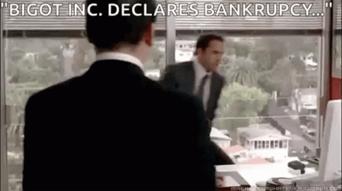 A Man In A Suit And Tie Is Standing In Front Of A Window In An Office . GIF