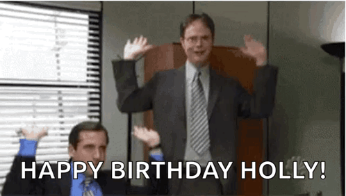 A Man In A Suit And Tie Is Standing In Front Of A Window With His Hands In The Air . GIF