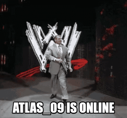 A Man In A Suit And Tie Is Standing In Front Of A Wwe Logo GIF