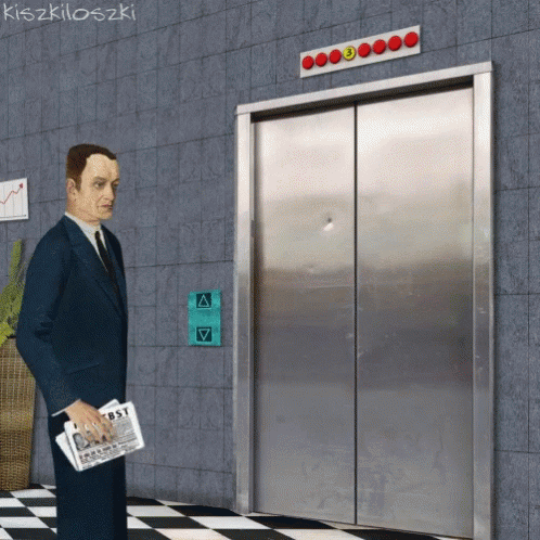 A Man In A Suit And Tie Is Standing In Front Of An Elevator With A Sign That Says First On It GIF