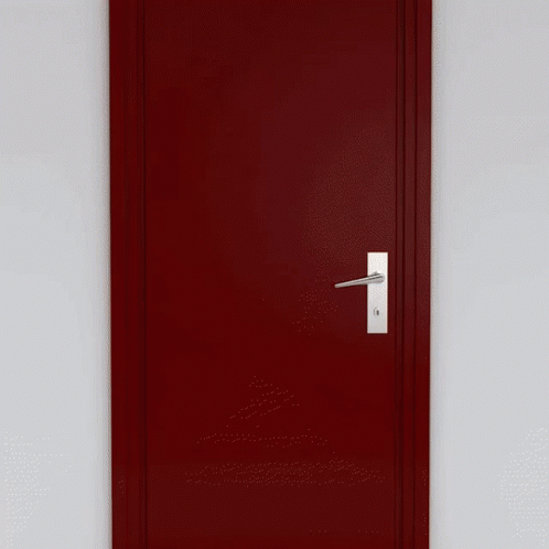 A Man In A Suit And Tie Is Standing In Front Of An Open Door GIF