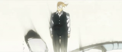 A Man In A Suit And Tie Is Standing In The Middle Of A Broken Wall GIF
