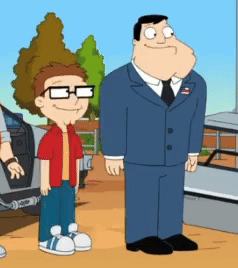 Man In Suit Standing Next To Boy With Glasses GIF