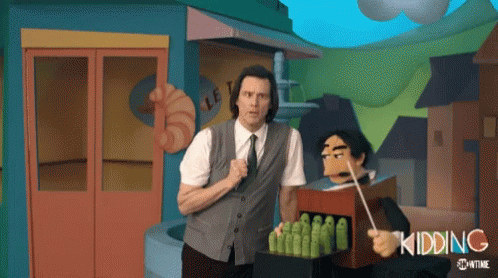 A Man In A Suit And Tie Is Standing Next To A Puppet With The Word Kidding Written On It GIF