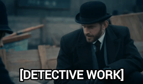 A Man In A Suit And Tie Is Standing Next To A Sign That Says Detective Work GIF