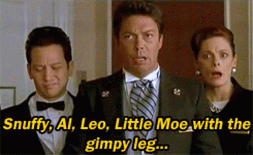A Man In A Suit And Tie Is Standing Next To A Woman And A Man In A Bow Tie GIF