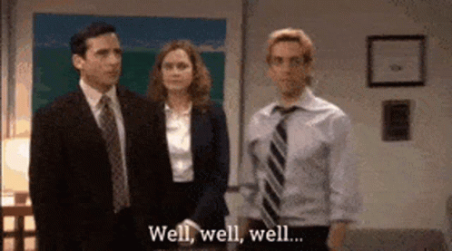 A Man In A Suit And Tie Is Standing Next To A Woman And A Man In A Suit And Tie . GIF