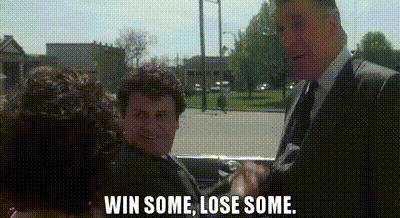A Man In A Suit And Tie Is Standing Next To A Woman In A Car And Talking To Her . GIF